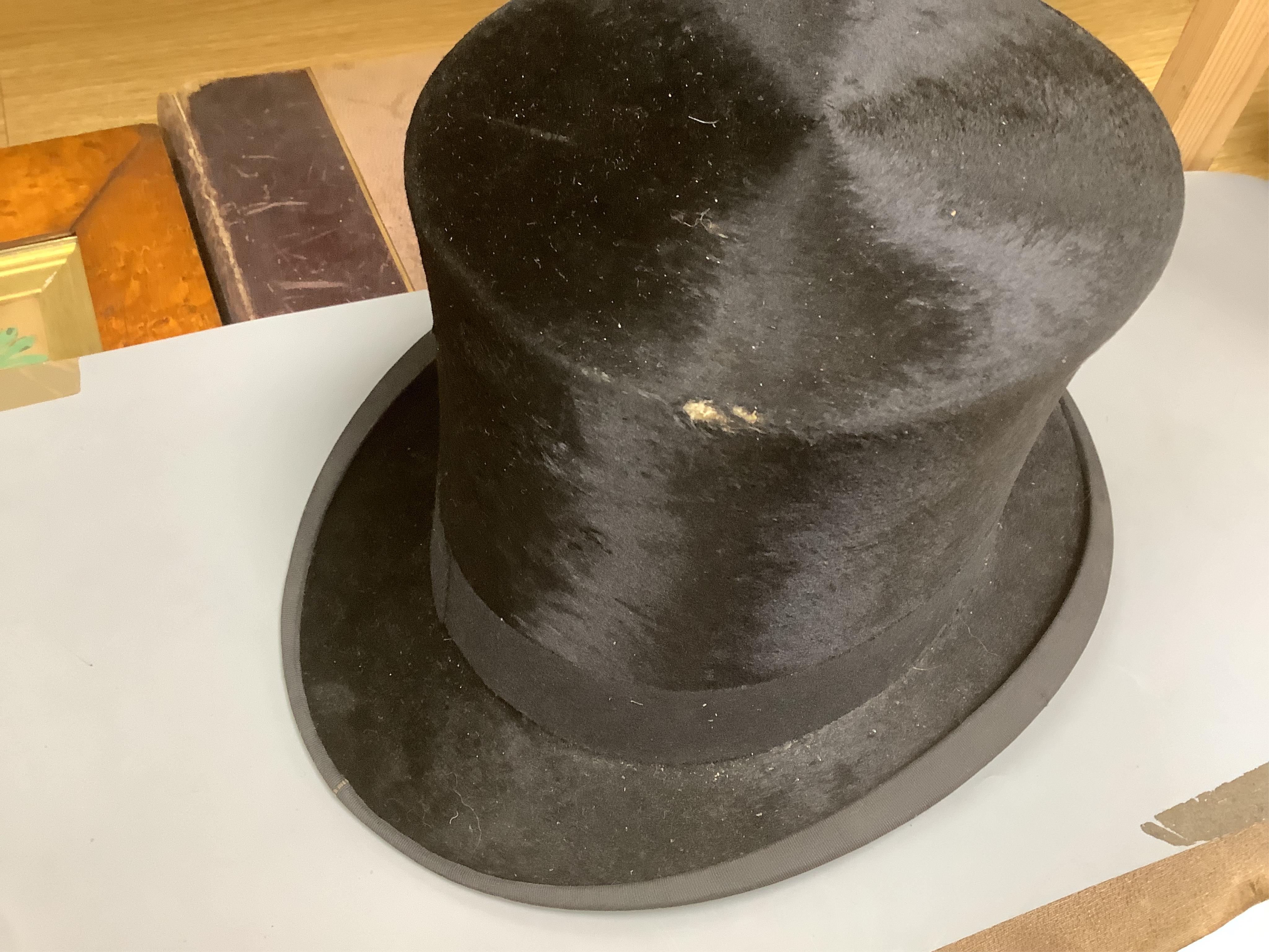 Three gentlemen’s black silk top hats and a similar grey top hat and box. Condition - grey hat good, others poor
